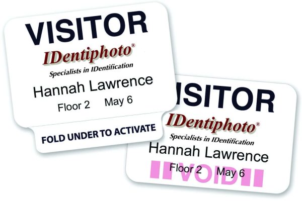 Two visitor badges for Hannah Lawrence from IDentiphoto, showing issue details and a VOID mark appearing after folding the badge.